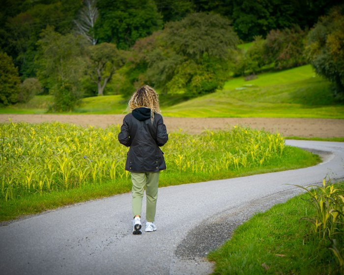 Heart care: a person walking on a path through a green park